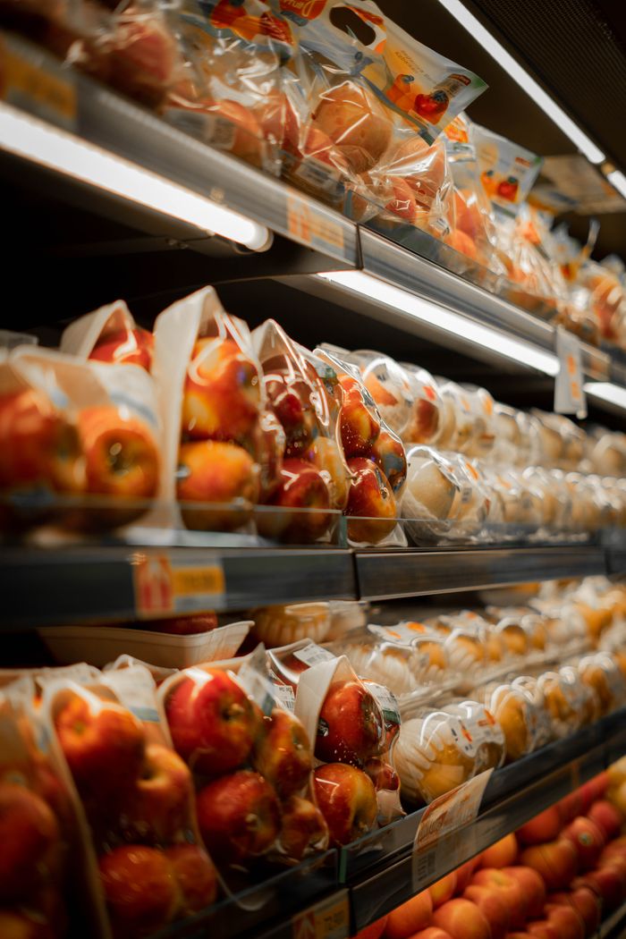 Mastering the First Impression: Your intriguing post title goes here Packaged fresh apples displayed on a supermarket shelf with bright lighting.